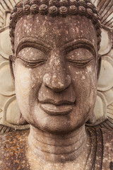 Stone meditating Buddha statue closeup and detail, Bouddha portrait, serenity and meditation concept