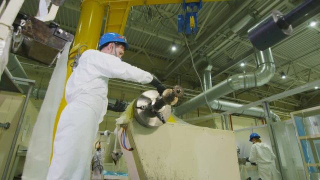 technician checks lubricating quality of machine rotating shaft at plant