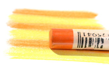 Orange pastel with yellow-orange shading on white background selective focus