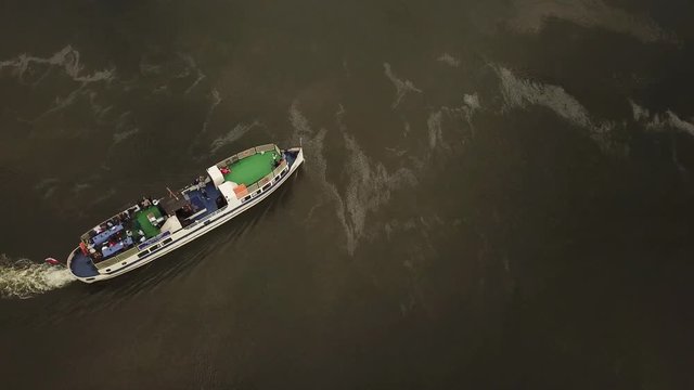 Tour boat ferry boat turning around on the river