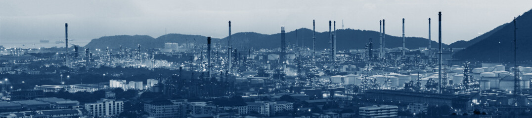 factory of industrial oil refinery and mountain view in blue filter