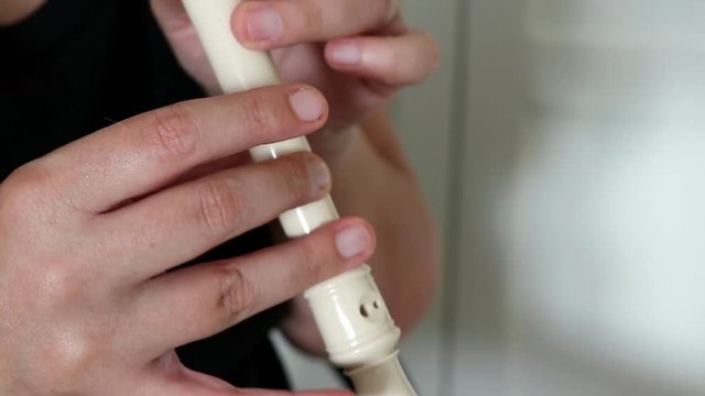 Musician playing the flute. Close up of hands of a flutist