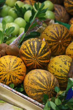 Bright fresh watermalon and fruits on the counter of the street night market. 