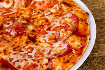 Obraz na płótnie Canvas Pepperoni pizza with sausages