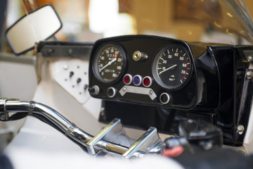 Motorbike or motorcycle dials, background. Devices on a steering bracket on the bike. Motorbike...
