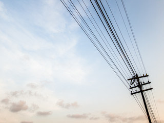 Rusty electricity post with wire on the sky background in the rural area or Thailand.