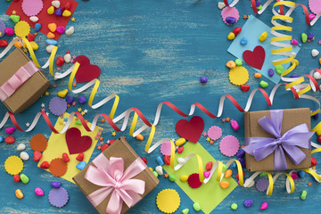 Decorative holiday background with streamers confetti candy hearts decor.