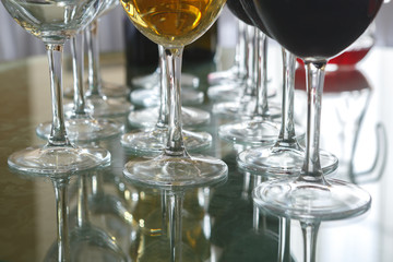 Legs of glasses with red and white wine