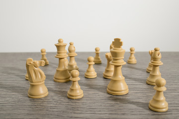 Chess and pawns on a decorated wood table