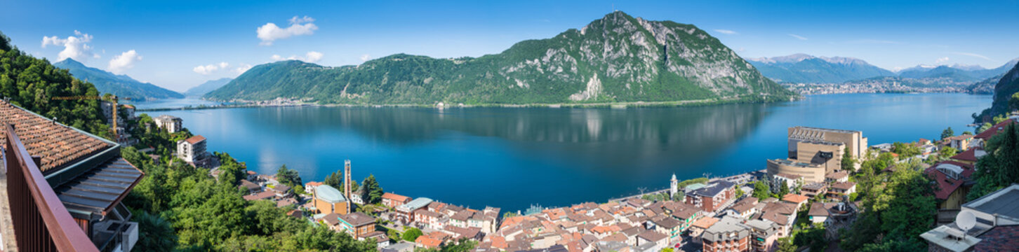 Lake Lugano. Panoramic view of Campione d'Italia, famous for its casino. In the background on the right the city of Lugano, in the middle Monte San Salvatore, on the left Melide and Monte San Giorgio