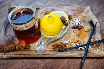 Folk medicine .Healthy and tasty honey bee in glass jar and citruses and spices Selective focus, top view.

