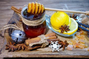 Folk medicine .Healthy and tasty honey bee in glass jar and citruses and spices Selective focus,...
