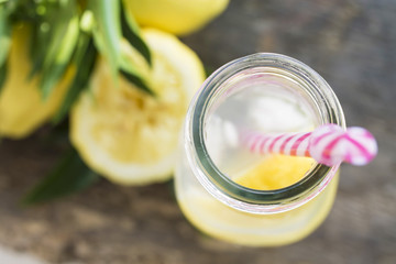 homemade refreshing summer lemonade drink , lemon slices and ice in mason jars