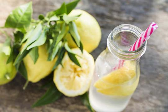 homemade refreshing summer lemonade drink , lemon slices and ice in mason jars