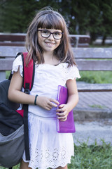 student with books in the park, back to school