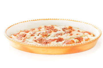 Homemade stuffed cannelloni (cannelloni di magro) with spinach and ricotta covered with tomato sauce, bechamel and grana cheese. Fresh stuffed pasta, Italian cuisine, white background 