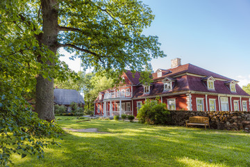Old big wooden house in the park. Traditional scandinavian styled vintage living place.