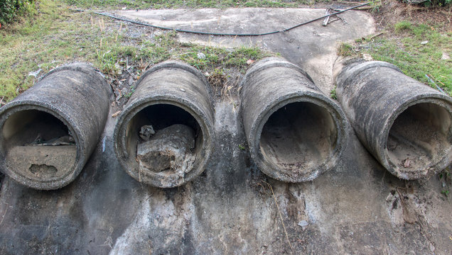 Dry concrete pipes for drainage water on shore. Sewage system.