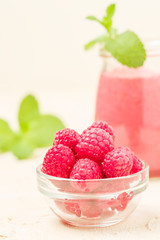 Raspberry smoothie close up photography with fresh summer blended cocktail and ripe berries.