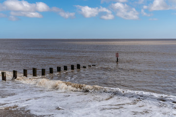 View towards the North Sea and a wave breaker in Gorleston-on-Sea, Norfolk, England, UK