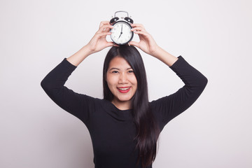 Young Asian woman smile with a clock.