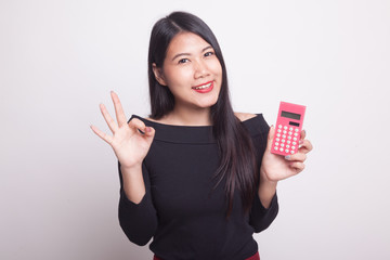 Asian woman show OK with calculator.