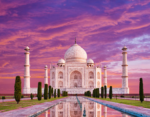 Amazing view on the Taj Mahal in sunset light with reflection in water. The Taj Mahal is an white marble mausoleum on the south bank of the Yamuna river. Agra, Uttar Pradesh, India