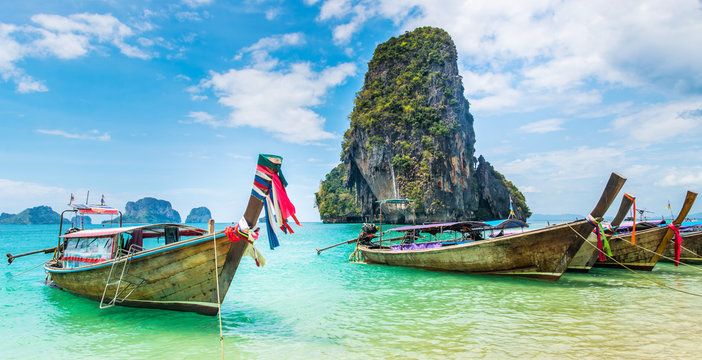 Amazing view of beautiful beach with longtale boats. Location: Railay beach, Krabi, Thailand, Andaman Sea. Artistic picture. Beauty world. Panorama
