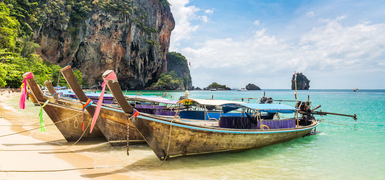 Amazing view of beautiful beach with longtale boats. Location: Railay beach, Krabi, Thailand, Andaman Sea. Artistic picture. Beauty world. Panorama