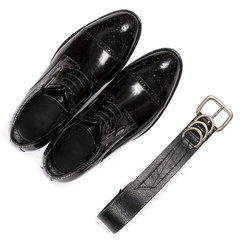 Close up of modern man accessories. bow tie, leather shoes, belt on white background.