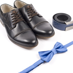 Close up of modern man accessories. bow tie, leather shoes, belt on white background.