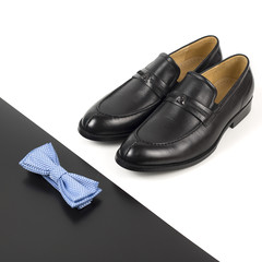 The black man's shoes and accessories isolated on white and black background.
