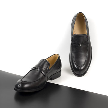 Classic male black leather shoes isolated on a white and black