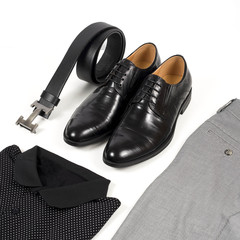 Men's leather shoes and belt on a white background