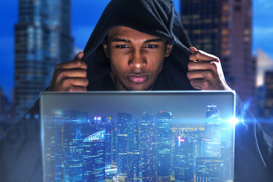 Hacker with laptop in night city