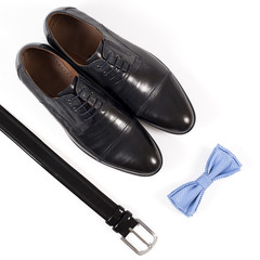 Set of male stylish clothes on white background, leather belt, shoes and bow tie