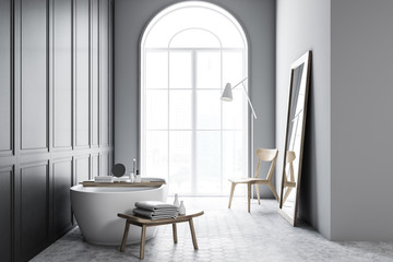 Fototapeta na wymiar Bathtub with water in grey bathroom interior