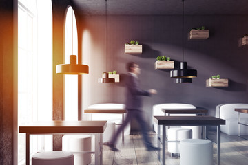 Businessman in black wall cozy restaurant interior