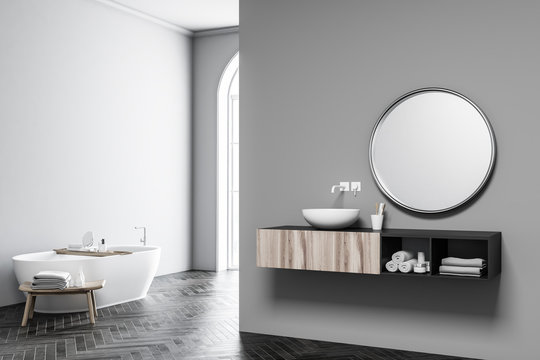 Grey arched window bathroom, tub and sink