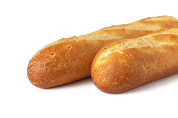 Two fresh baguettes with a delicious crust, isolated on a white background. Fresh bread