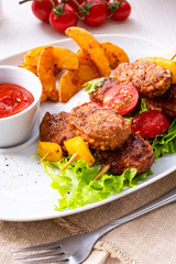 rustic Meatballs skewers of tomato, paprika and baked potato quarters