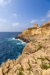 Fototapeta na wymiar Wied Iz-Zurrieq, Malta. Scenic view with an old watch tower on a rocky shore