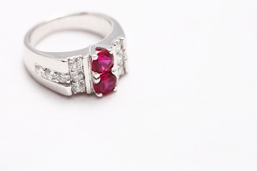 Pink gem stone on diamond ring