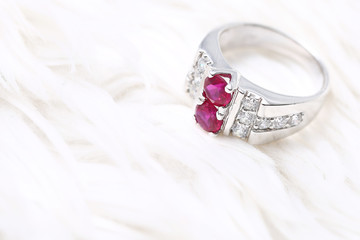 Pink gem stone on diamond ring