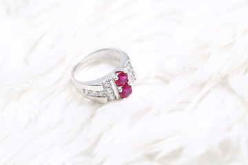 Pink gem stone on diamond ring