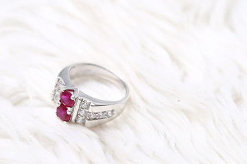 Pink gem stone on diamond ring