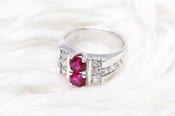 Pink gem stone on diamond ring