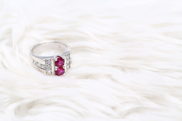 Pink gem stone on diamond ring