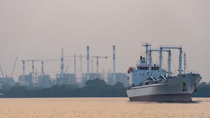 White reefer ship or refrigerated cargo ship sails in Chao Phraya river