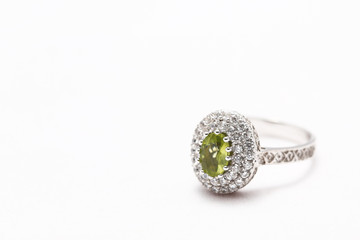 green gem stone on diamond ring